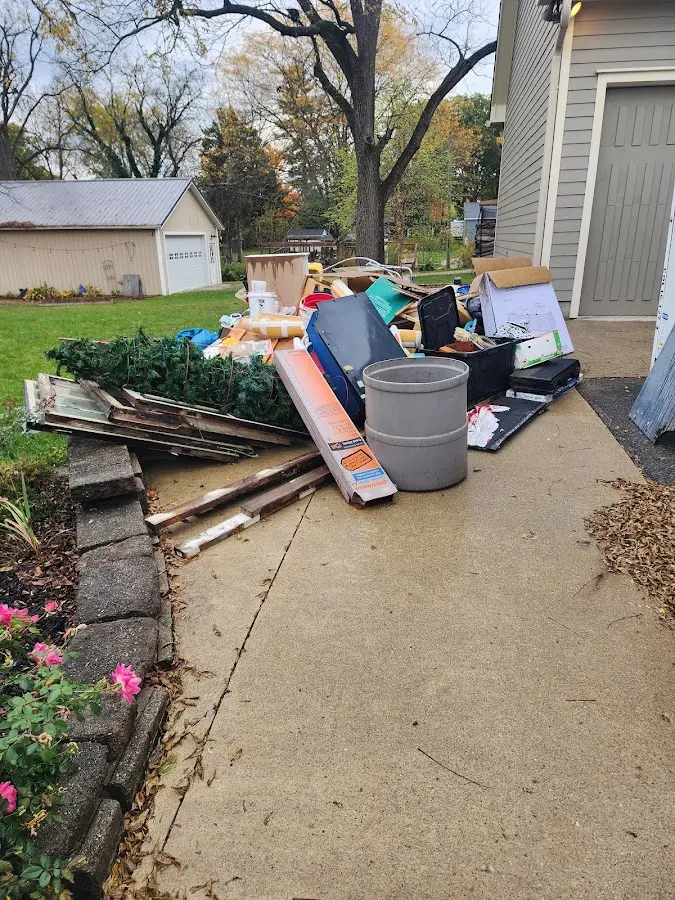 Dumpster being loaded with debris for Roofing Dumpster Rental in Dunwoody